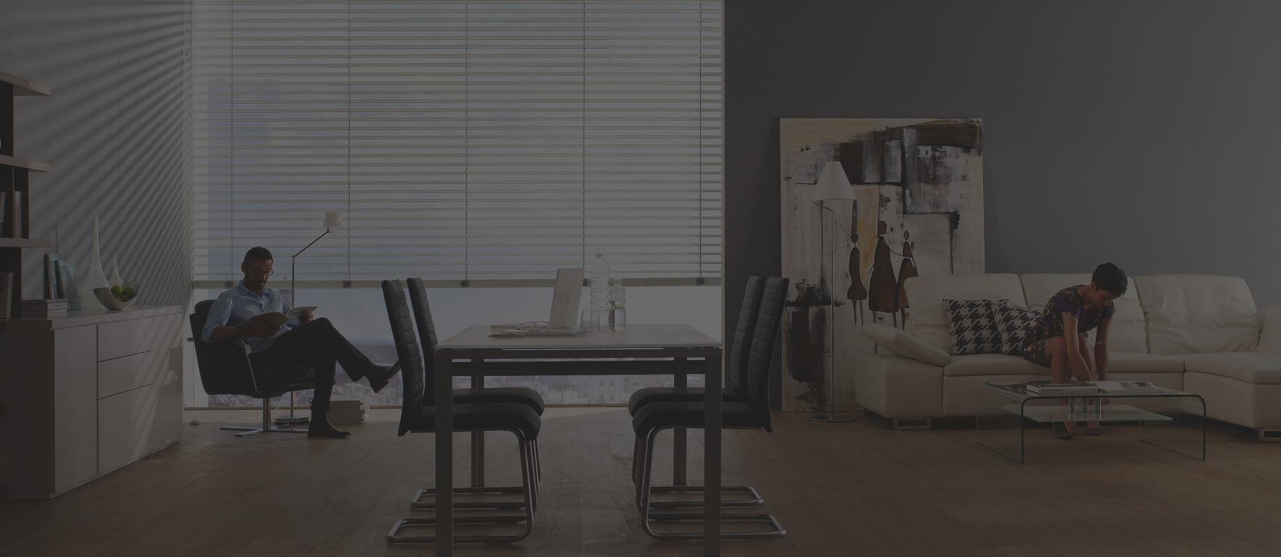 Man and woman sit in a living room