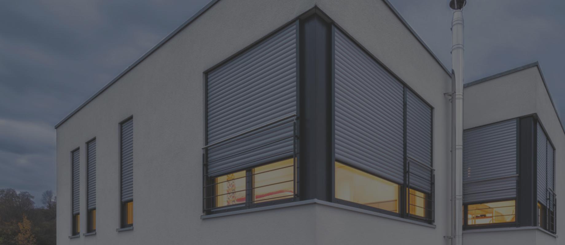 Single-family home detailed view window with nearly closed roller shutters