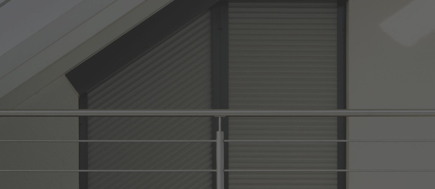 Window close-up roof slope with angled roller shutter TRENDO