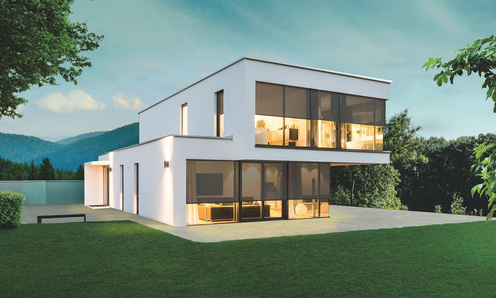 Modern model home in the twilight with interior lighting, textile screens