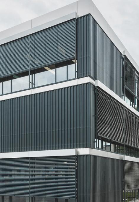 Modern office building with façade venetian blinds by daylight