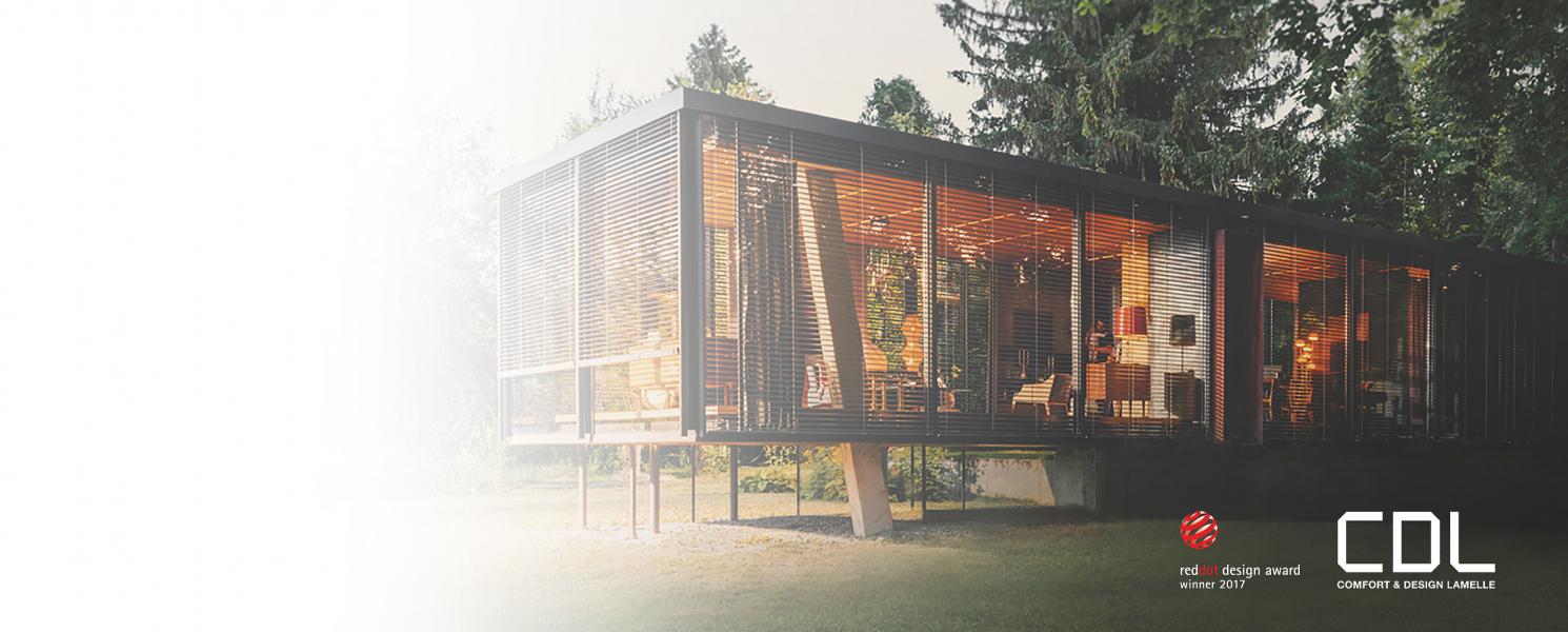 Modern window bungalow on stilts with external venetian blinds in the country by daylight