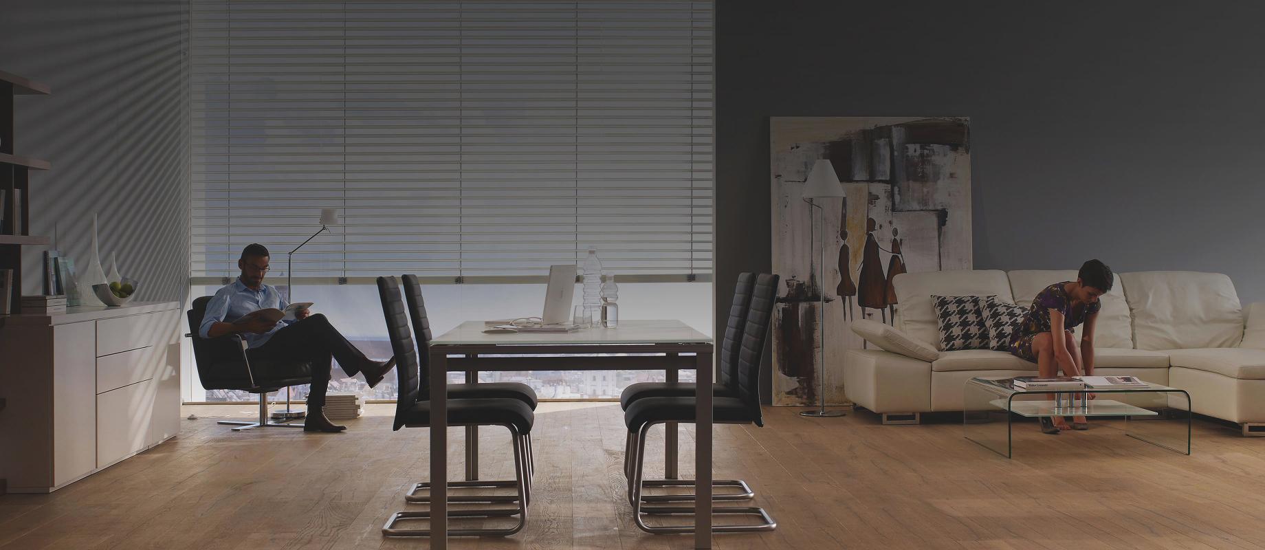 Man and woman sit in a dining/living room