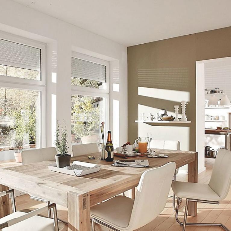 Dining room by daylight with roller shutters nearly open