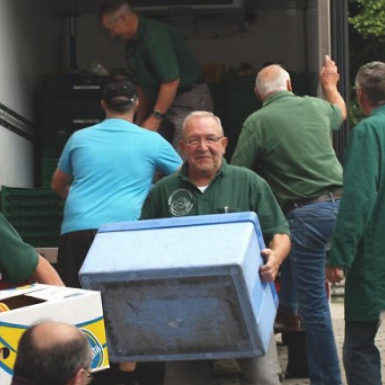 Burgau Food Bank Meets Apprentices Image section, various men unload truck