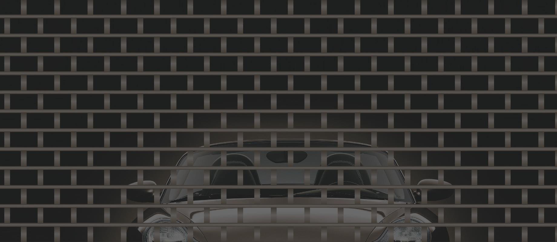 Porsche stands behind a closed roller grille