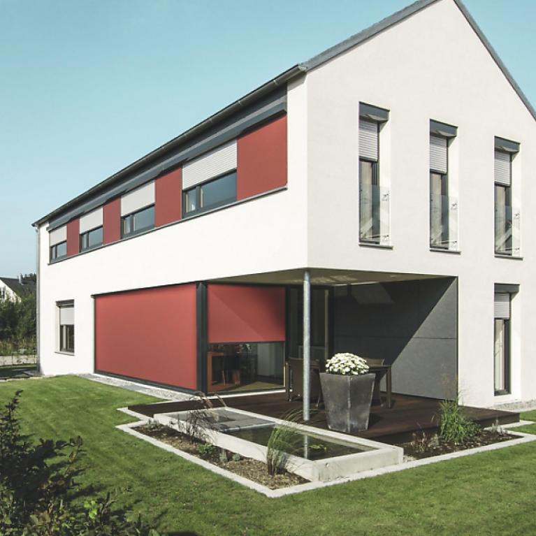 Residential building detail with slightly lowered textile screens by daylight