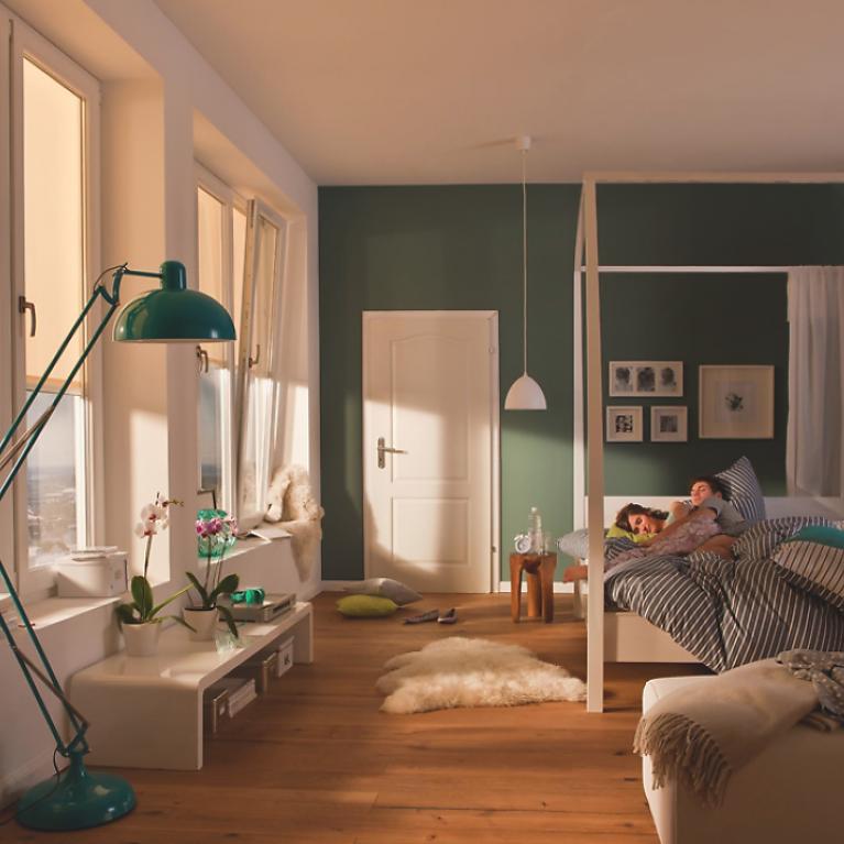 Bedroom from the inside, with half lowered textile screens by daylight