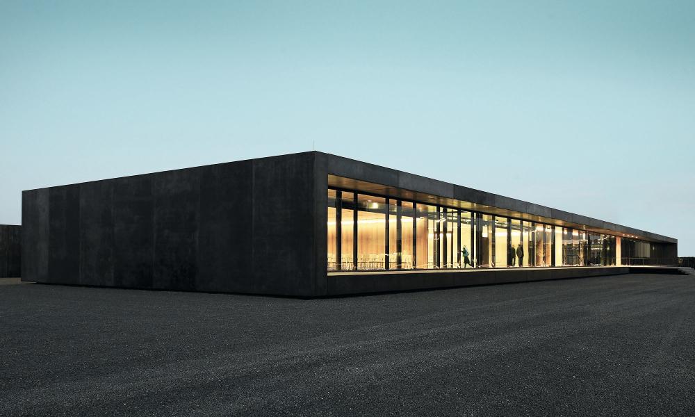 ROMA Forum, modern concrete construction in the twilight with interior lighting