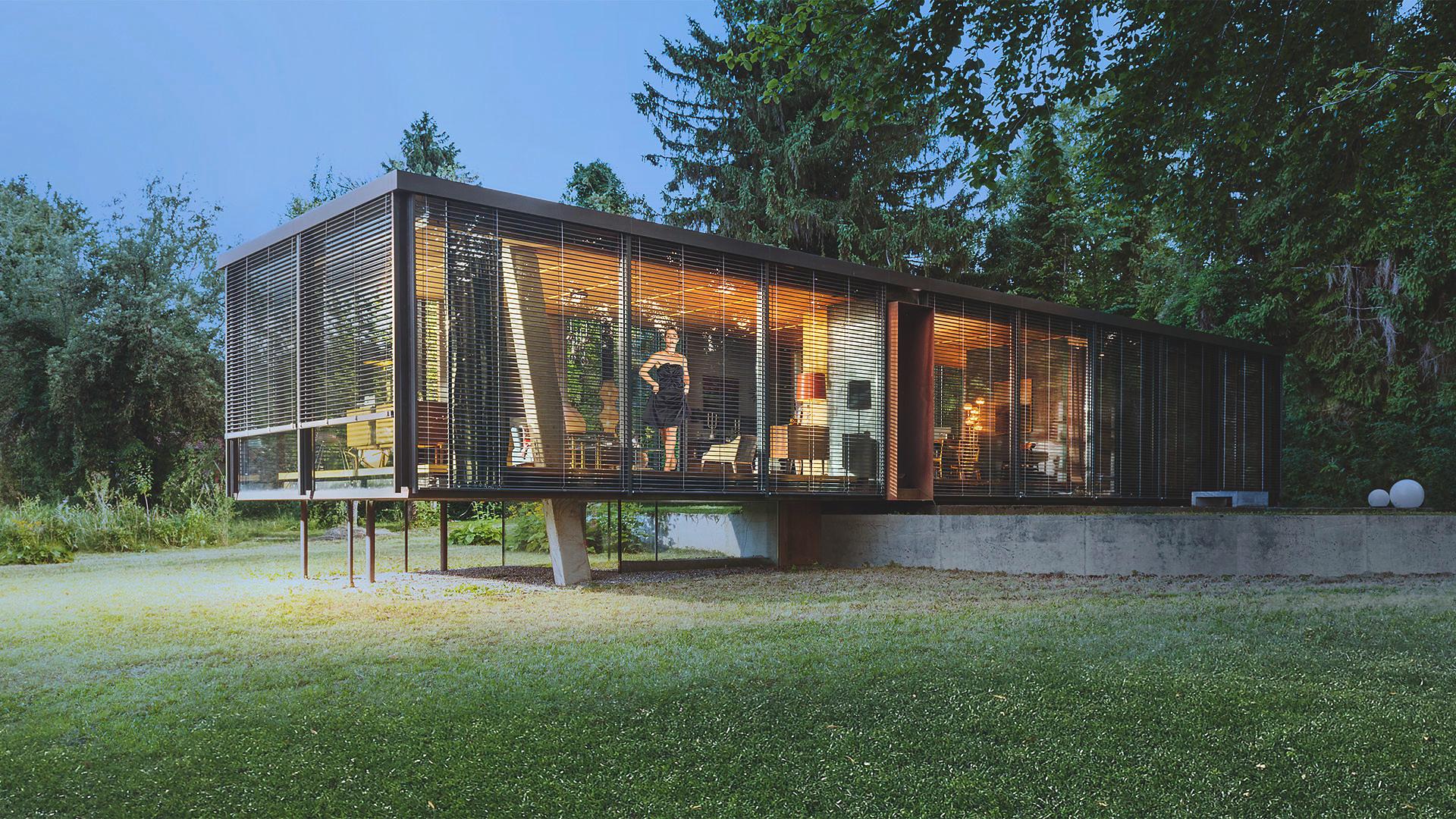 Modern window bungalow on stilts with external venetian blinds in the country by daylight