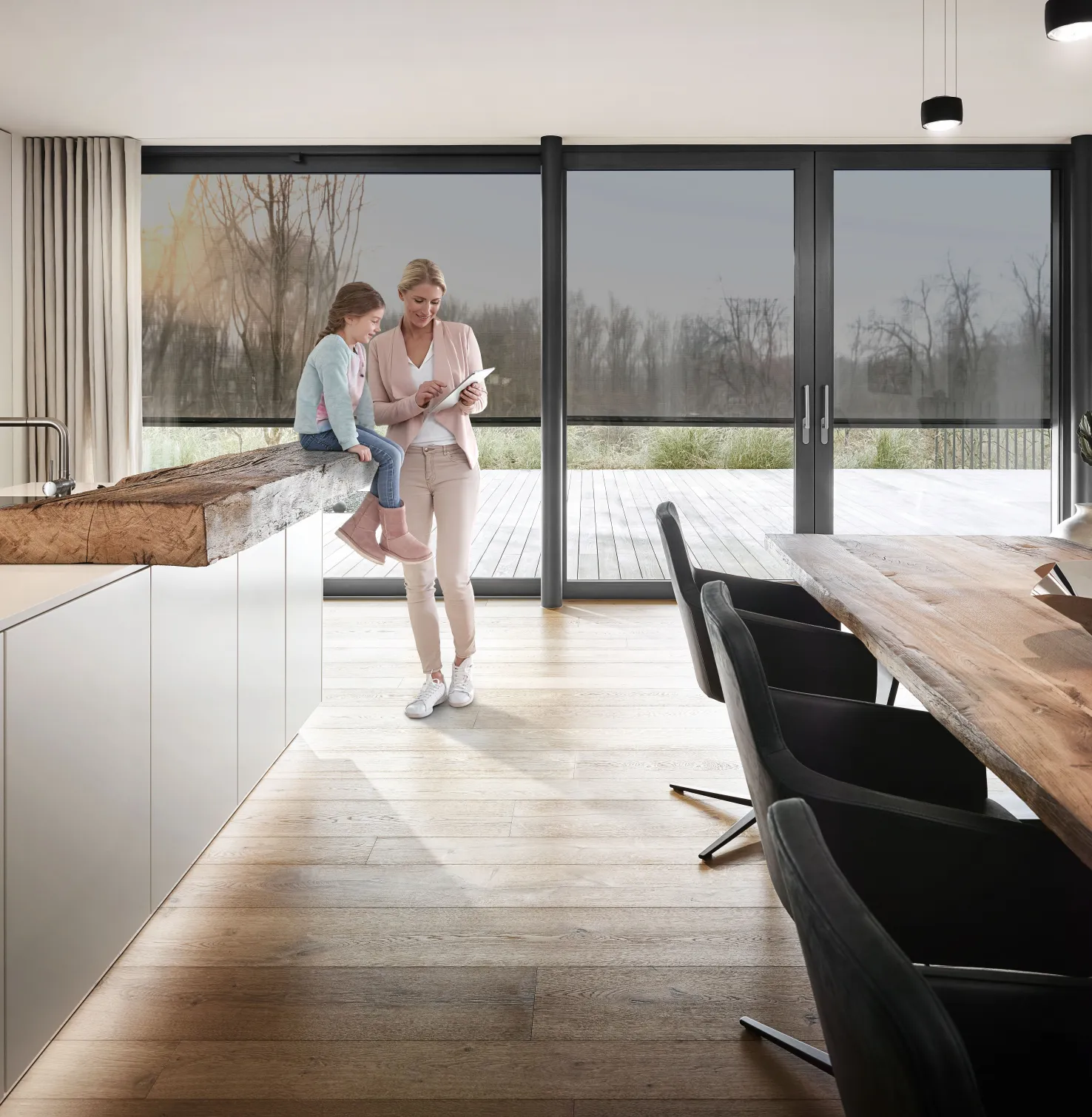 Kitchen with ROMA Textile Screens and woman with her child at the counter